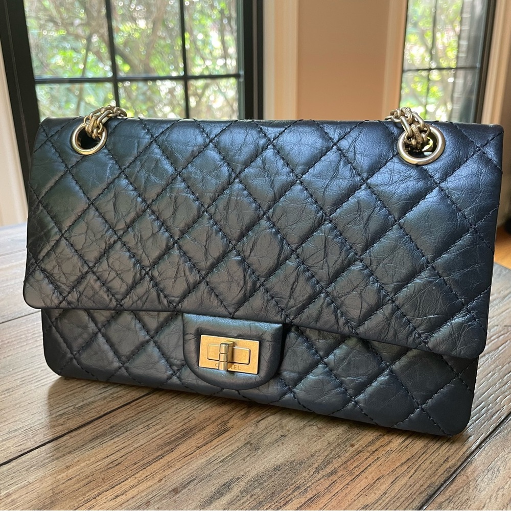 CHANEL Black Aged Calfskin Quilted 2.55 Reissue 225 Flap Antiqued Gold hardware.
